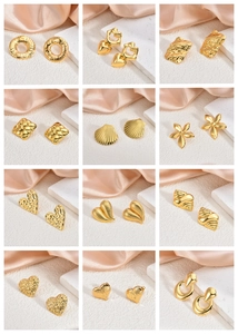 Detailed collection of twelve 18K gold plated geometric stud earrings on silk