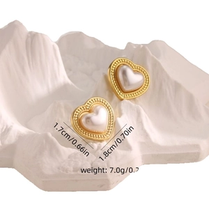 French luxury gold heart earrings with white pearl inlay and vintage aesthetic