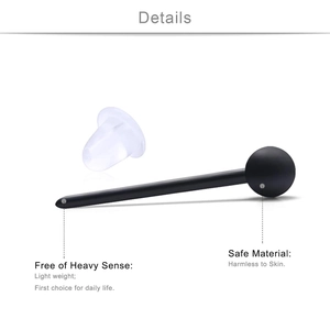 Close-up of black matte acrylic ball studs with skin-safe transparent rubber backings