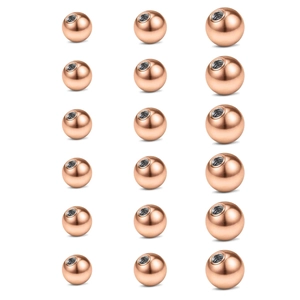 Macro view of 18 rose gold replacement balls with internal threads for body piercings