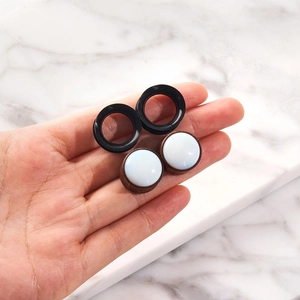 Pair of black silicone tunnels and wood ear plugs with white stone inlay set