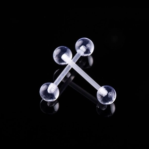 Macro shot of two transparent acrylic barbell piercings with clear balls on black mirror