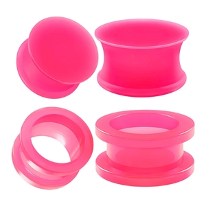 Detailed view of neon pink double flare silicone ear plugs and tunnels four-piece set
