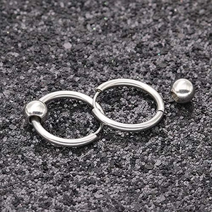 Macro shot of polished stainless steel hoop earrings with round bead charms on dark background