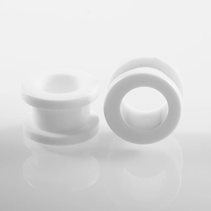 Detailed close-up of white acrylic ear tunnels with polished finish and smooth surface