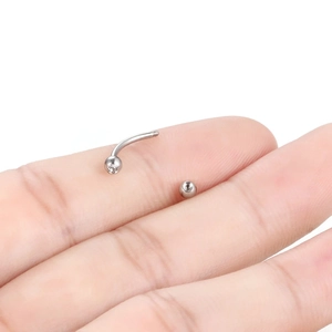 Macro shot of curved eyebrow piercing jewelry with sparkling zircon and internal threading
