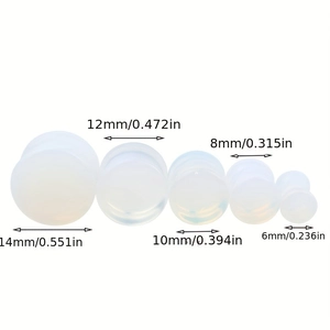 Set of five white opal ear plugs in sizes from 6mm to 14mm with diameter labels