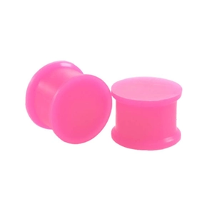 Macro view of pink silicone double flared ear plugs showing smooth texture and shape