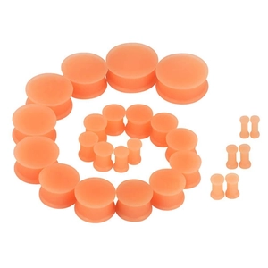 Detail view of skin-toned silicone ear gauges set in various sizes with flexible material