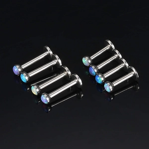Set de 8 piercings labret de acero inoxidable con ópalo sobre fondo negro brillante