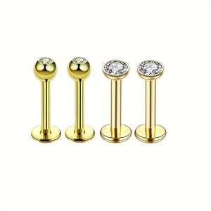 Lot de quatre piercings labret en acier doré sertis de zircons cubiques brillants