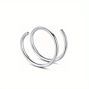 Macro detail of the high-polished stainless steel double nose ring with ball endings