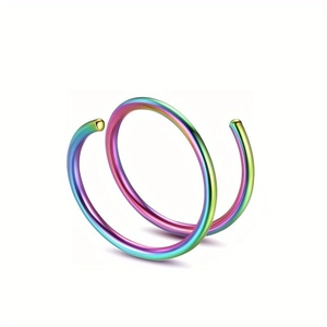 Macro detail of rainbow iridescent stainless steel double spiral piercing ring