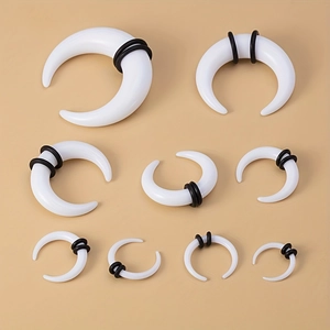 9-piece set of white acrylic buffalo horn ear tapers with black O-rings in various sizes