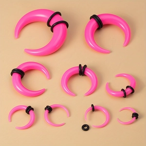 Nine pairs of bright pink acrylic ear taper stretchers with black rubber O-rings in various sizes