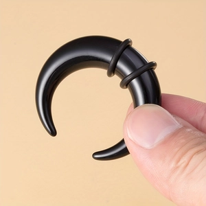 Detail of a black acrylic buffalo horn ear taper with two secure rubber O-rings