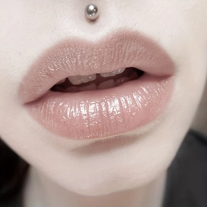 Glossy pink lip gloss with mirror finish and surgical steel ball labret piercing kit
