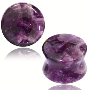 Macro detail of purple amethyst ear plugs showing natural stone texture and curved profile