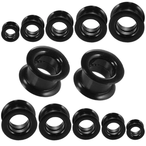 Detailed set of black silicone ear gauges in multiple sizes for piercing stretching
