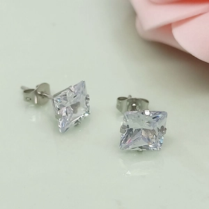 Macro shot of silver square cubic zirconia stud earring with four-claw setting