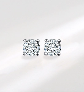 Detailed view of 925 sterling silver solitaire stud earrings with four-prong settings