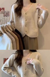 Detail view of V-neck knitted cardigan showing soft texture and wooden button closure