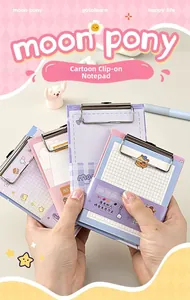 Detailed view of mini A6 clipboard notepad with metal clip and cute cartoon illustrations