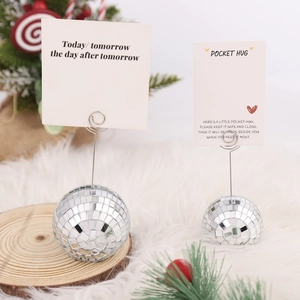 Close-up of silver disco ball place card holders with spiral wire for wedding table decor