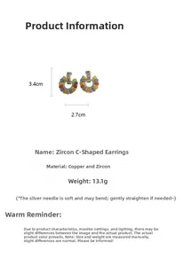 Detailed view of C-shaped drop earrings with colorful zircon inlay and copper plating