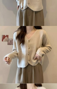 Detailed close-up of cream V-neck knit cardigan with round buttons and plush texture