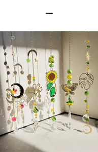 Golden suncatcher showing crystal prism refraction and rainbow light patterns on a white wall