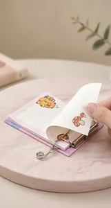 Close-up of A6 mini binder notepad featuring refillable metal rings and cute bear illustrations
