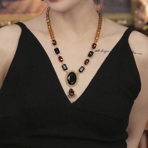 Vintage necklace with amber beads, purple gem and waterdrop pendant on model