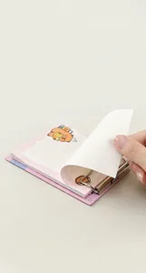 Macro detail of cute bear A6 notepad featuring refillable metal rings and line pages