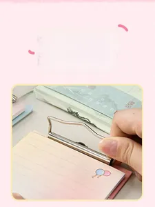 Detail of a6 memo pad featuring a durable silver metal clip and cute pink balloon design