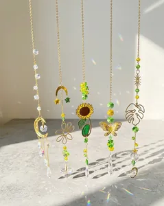 Close-up of golden suncatchers with crystal prisms casting rainbows on floor