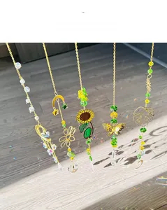 Close-up of golden suncatchers with crystal prisms casting rainbows on floor