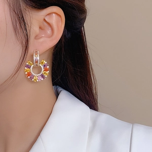 Exquisite gold C-shaped earrings with colorful zirconia gemstones and drop design