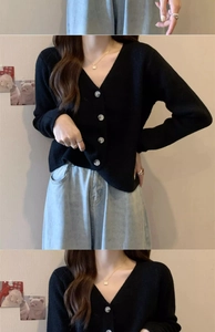 Detail view of V-neck knitted cardigan with grey buttons and high-waist denim jeans