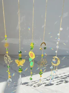 Detail view of five golden crystal suncatchers with rainbow prisms on wood surface