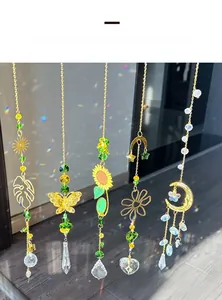Detail view of five golden crystal suncatchers with rainbow prisms on wood surface