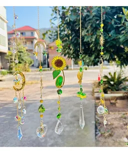 Detail of five golden suncatchers with K9 crystal prisms, moon, and sunflower designs