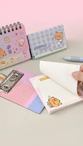 Close-up of A6 notepad with cute bear illustration and silver metal clip for stationery