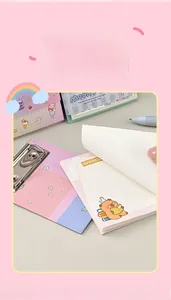 Close-up of A6 notepad with cute bear illustration and silver metal clip for stationery