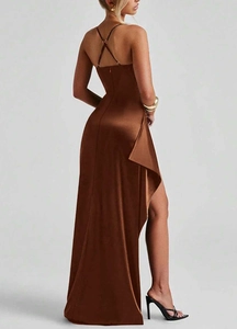 Detail of cross-back straps and high side slit on a brown satin evening maxi dress