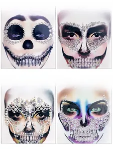 Detailed view of four Halloween face gem stickers with resin rhinestones and skeleton designs
