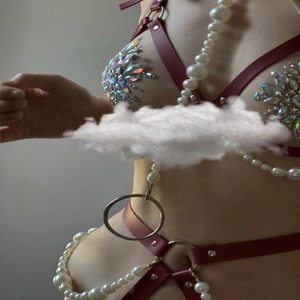 Red leather body harness with large white pearls and iridescent rhinestones for music festivals