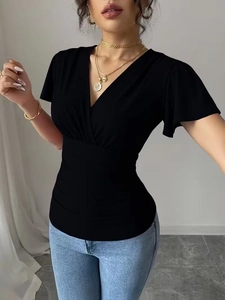 Detail of slim fit black V-neck top featuring ruffled sleeves and gathered waist design