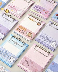 Detailed macro view of macaron colored A6 clipboards with cute cartoon memo pads