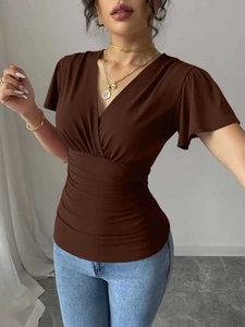 Detail of V-neck cross-over design and ruched waist on a brown short sleeve top